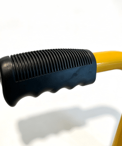 Wheel Chock Handle » Highway 1 Close-up of a black ribbed handle with a yellow curved tool body visible at the end.
