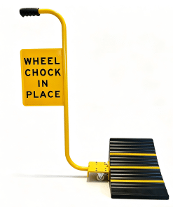 Wheel Chock on Wheels » Highway 1 Yellow wheel chock device with a curved yellow support and a panel that reads 'WHEEL CHOCK IN PLACE' against a white background.