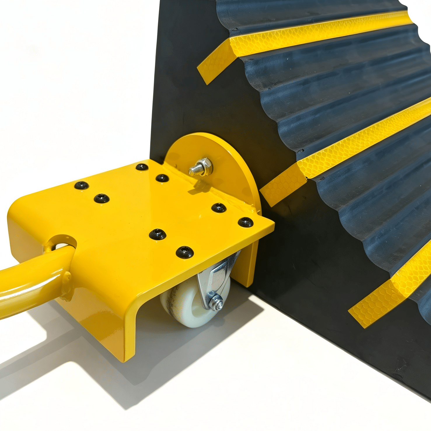 Wheel Chocks Attachment Brackets » Highway 1 Close-up of a yellow wheeled industrial trolley attached to a black corrugated track with yellow safety tape; a white wheel supports the assembly and a bolt passes through a yellow bracket.